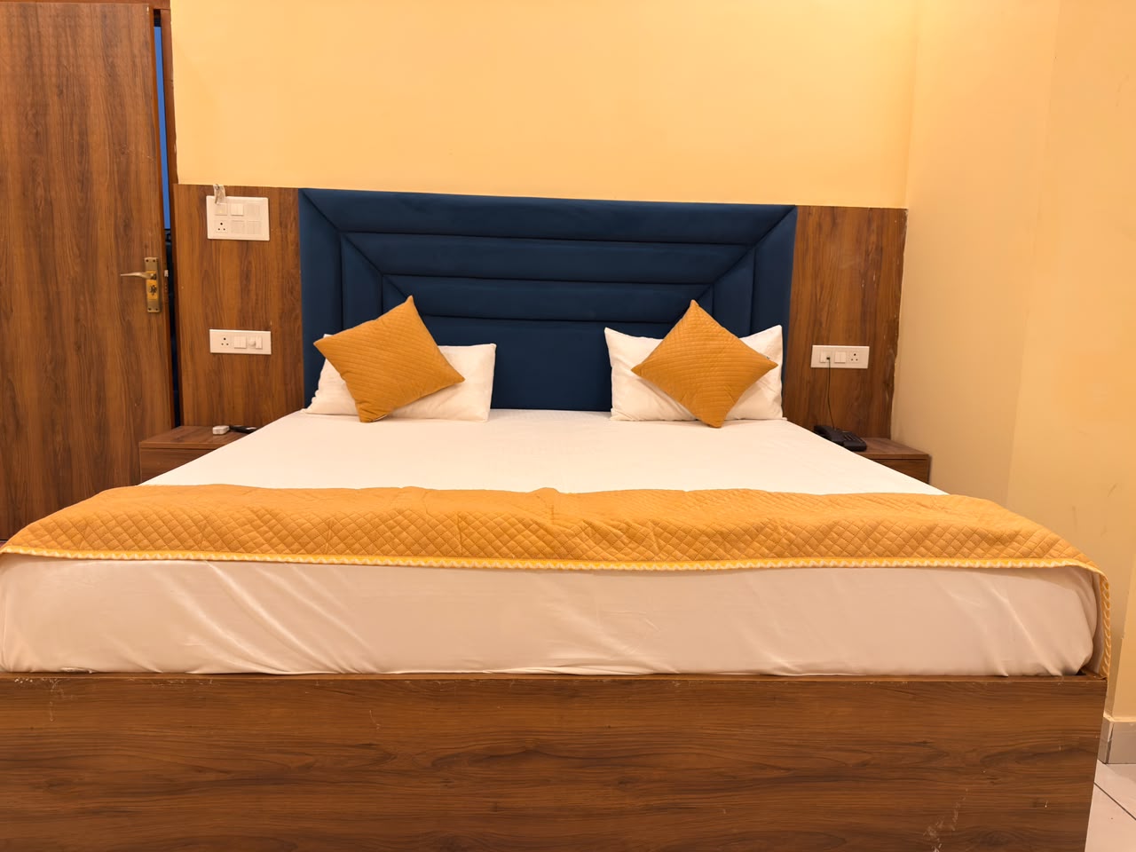 Bed detail in a guest room at Vedic Portico Hotel